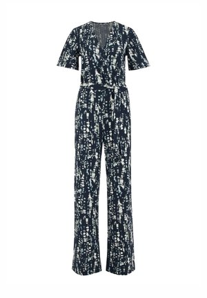 Combinaison bleu marine avec des motifs abstraits blancs, décolleté en V, manches courtes, taille cintrée avec une ceinture et pantalons à jambe large.