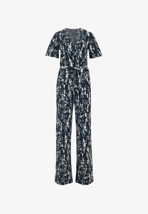 Tumši zilā kombinezona ar baltām abstraktām līnijām, V-veida kakla izgriezumu, īsām piedurknēm, pieguļošu jostasvietu ar jostu un platām biksēm.