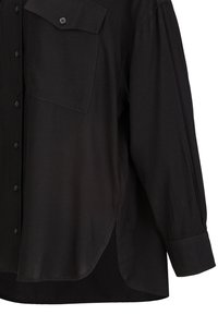 Black long-sleeve button-up shirt with a single buttoned chest pocket and curved hem with side slit.