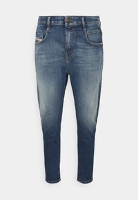Denimjeans i mörkblått med en blekt effekt. Har en standard midja, fem fickor och en avsmalnande bendesign.