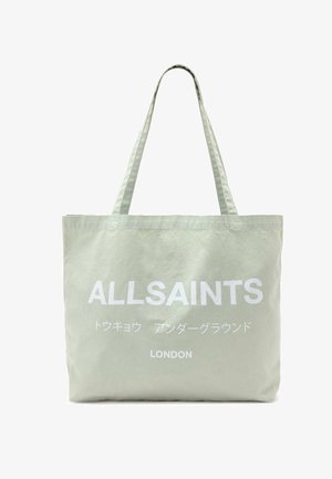 Jasnobeżowa torba typu tote z nadrukiem "ALLSAINTS", japońskimi znakami oraz napisem "LONDON" w kolorze białym na przodzie, wyposażona w dwa paski na ramię.