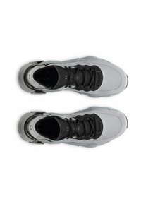 Pair of gray and black Under Armour running shoes viewed from above, showing laces, mesh texture, and cushioned soles.
