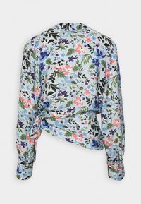 Floral blouse features a light blue background with a variety of colorful flowers, long sleeves, and a knotted design at the waist.