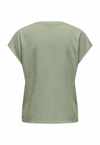 Kortärmad topp i ljusgrön, med en avslappnad passform, mjuk textur och en enkel rund halsringning. Inga synliga mönster eller detaljer.