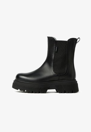 Black leather ankle boots with elastic side panels, chunky rubber sole, rounded toe, and a pull tab at the back for ease of wear.