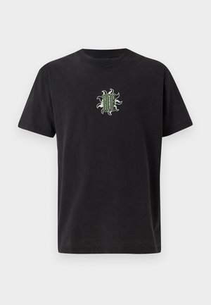 Black cotton t-shirt with a crew neckline. Features a green and white embroidered design on the chest. Short sleeves, standard fit.