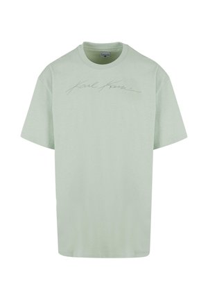 T-shirt verde chiaro a maniche corte in cotone morbido con colletto rotondo. Presenta un logo in rilievo e di colore contrastante.