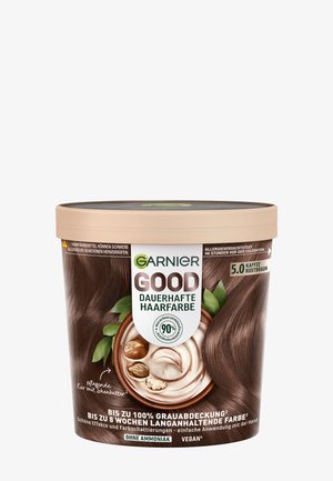 Garnier Goede haarkleur verpakking, ronde vorm, lichtbruine deksel, bruine textuurlabel met afbeeldingen van koffie en sheaboter, veganistisch, ammoniakvrij.