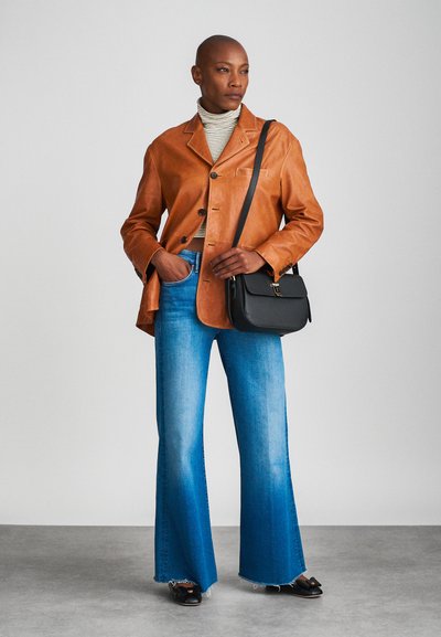 Brown leather jacket, striped turtleneck, flared blue jeans, black crossbody bag, casual black shoes; smooth texture and tailored fit.