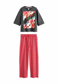 Gray short-sleeve top with a festive print. Red pajama pants with white checkered pattern. Soft fabric, relaxed fit, elastic waistband.