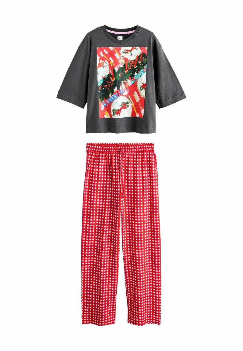 Gray short-sleeve top with a festive print. Red pajama pants with white checkered pattern. Soft fabric, relaxed fit, elastic waistband.