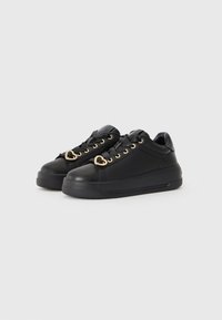 Black sneakers with a smooth leather finish, featuring gold hardware accents, heart-shaped details on laces, and a thick black rubber sole.