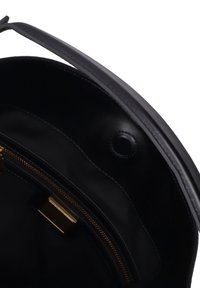 Borsa tote in pelle nera con una finitura liscia, dotata di chiusura con zip, accessori in metallo dorato e un interno spazioso.