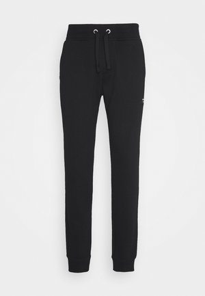Zwarte slim-fit joggingbroek met elastische tailleband, trekkoord en omgeslagen enkels, getoond tegen een effen lichte achtergrond.