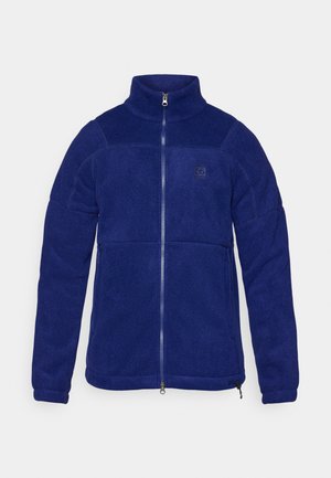 Marineblaue Fleecejacke mit hohem Kragen, durchgehendem Reißverschluss und einem Logo auf der Brust. Sie verfügt über eine glatte Textur und kontrastierende Nähte.