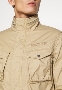 Schott Lehká bunda - sand