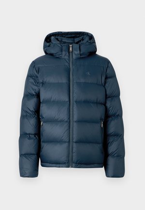 Navy blue puffer jacket with a hood, quilted design, zip closure, and side pockets. Smooth texture and minimal branding visible.