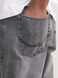 Gray denim jeans with a pocket detail featuring contrasting stitching. Material appears textured; relaxed fit with side pocket visible.