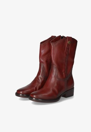 Red leather ankle boots with a smooth texture, rounded toe, and a mid-height block heel. Features decorative stitching and a side zip.