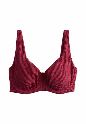 Roter, strukturierter BH aus Stoff mit Bügelunterstützung und breiten Schulterträgern, dargestellt vor weißem Hintergrund.