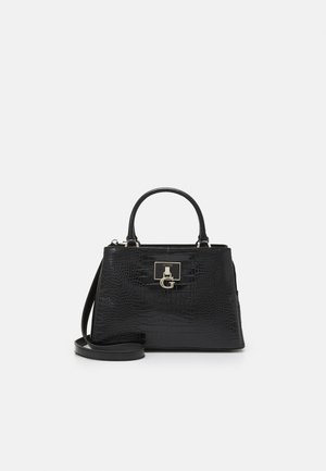 Black crocodile-texture handbag with top handles, detachable shoulder strap, and gold Guess logo clasp on front.