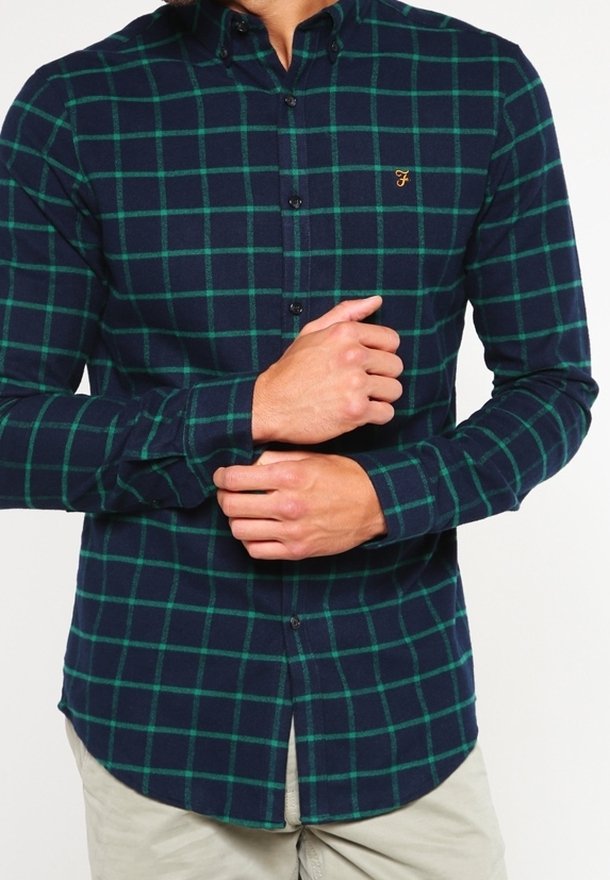Camicia a scacchi blu navy con motivo a griglia verde, colletto button-down, maniche lunghe e un piccolo logo dorato sul petto.