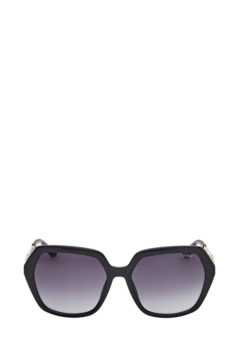 Zwarte hexagonale zonnebril met gradiëntlenzen, voorzien van een glad kunststof montuur en metalen accenten op het montuur.