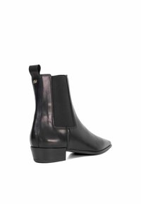 Black leather ankle boot featuring a sleek design, elastic side panels, and a low block heel. Notable polished finish and rear pull tab.
