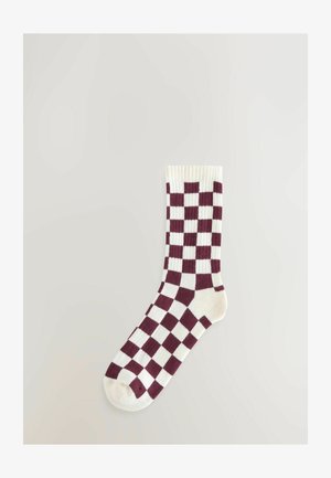 Bordo ja kreemjas ruuduline sokk ribatud äärisega. Omab kudumise mustrit vahelduvate square'idega. Pehme kangast tekstuur.