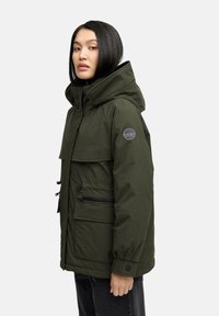 Olive green hooded jacket with a front zipper, two side pockets, and a logo patch on the sleeve. Smooth, matte finish, loose fit.