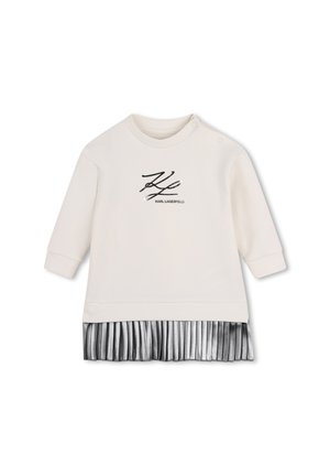 Haut crème à manches longues pour tout-petit avec logo noir "KL" et texte Karl Lagerfeld, avec un détail de jupe plissée argentée à l'ourlet.
