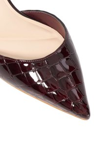 Burgundy patent leather pointed-toe pump with a crocodile pattern, smooth inner lining, and a tan sole, showcasing a sleek, modern design.