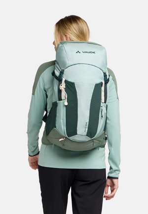 Zaino blu-verde chiaro con spallacci regolabili, tasche laterali in rete e un'apertura superiore. Presenta un design elegante ed ergonomico e un tessuto resistente.
