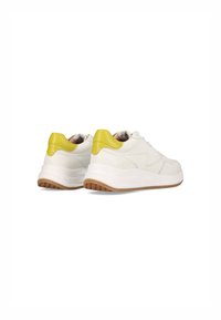 White sneakers with a curved design, textured rubber outsole, and a yellow accent at the heel. Smooth leather upper with minimal stitching.