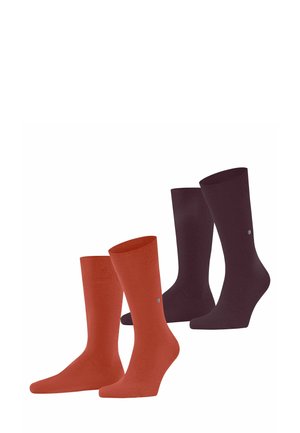Two pairs of socks are displayed: one orange and one dark purple. Each pair features a ribbed design and a small logo near the top.