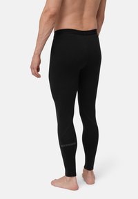 Schwarze Thermoleggings aus dehnbarem Material, mit einem enganliegenden Bund und "EXTREME"-Markierung entlang des Unterschenkels.