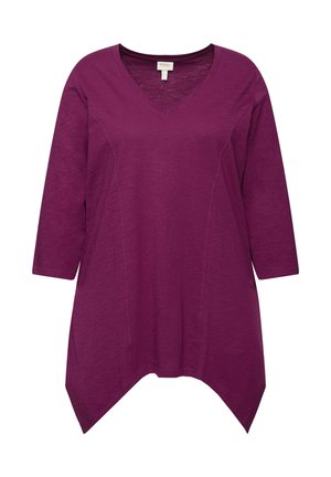 Tunique viola con scollatura a V e maniche a tre quarti, caratterizzata da un tessuto testurizzato e un design orlo asimmetrico. Materiale morbido e leggero.
