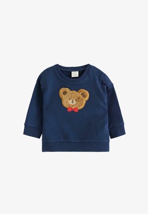 Dunkelblaues Baby-Sweatshirt mit gerippten Bündchen, das auf der Vorderseite ein flauschiges Teddybaergesicht-Patch mit einer roten Fliege zeigt.