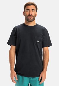 Black cotton t-shirt with short sleeves and a chest pocket; features a small logo on the pocket and a classic crew neck design.
