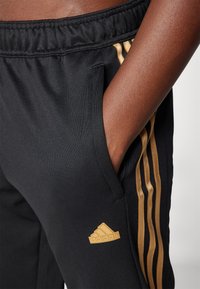 adidas Sportswear TIRO CUT 3 STRIPES TRACKPANTS - Treniņtērpa apakšdaļas - black/team victory red/tan