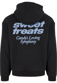 Black hoodie with a kangaroo pocket and a drawstring hood. Features large light blue text printed on the back: "sweet treats" and "Candy's Loving Symphony."