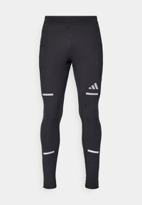 Leggings de sport noirs avec un design ajusté, fabriqués à partir d'un matériau extensible. Dotés d'accents réfléchissants et de poignets zippés pour plus de fonctionnalité.