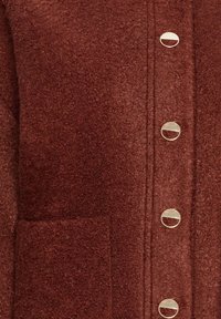 Brauner strukturierter Cardigan mit fünf goldfarbenen runden Knöpfen und einer Fronttasche, aus einem weichen, gewebten Stoff.