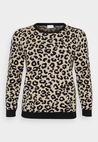Løveprikket genser i beige med svarte flekker. Har rund hals og svart ribbestrikket kant nederst og ved ermene. Laget av strikket stoff.