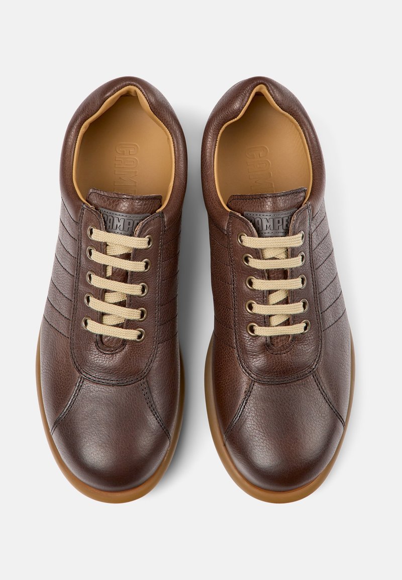Brown leather shoes with a smooth texture, round toe, and contrasting beige laces. Features horizontal stitching on the sides and rubber sole.