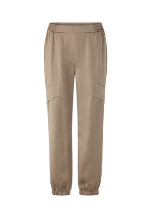 Beige elastic waist joggers with a smooth finish, featuring side pockets, tapered cuffs, and a slim fit design.