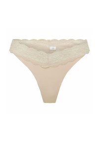 Tanga de encaje beige con una cinturilla de encaje con forma de ondas. Tejido suave con cobertura mínima y una etiqueta en la costura interior.