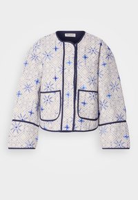 Padded jakna iz kremaste tkanine z modrimi geometrijskimi vzorci. Ima zaobljen ovratnik, mornarsko modre obloge in dve sprednji žepni zadnji.