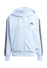 Ljust blå zip-up hoodie med en framficka, svarta sidostråk och en liten svart logotyp på bröstet. Mjuk tyg med en texturerad finish.