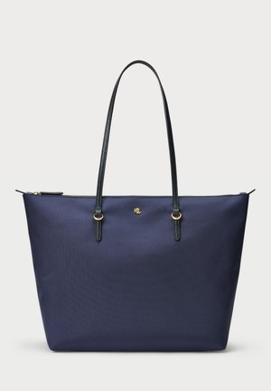 Borsa tote blu navy realizzata in tessuto testurizzato, con manici in pelle nera e dettagli in hardware dorato. Chiusura a zip nella parte superiore.